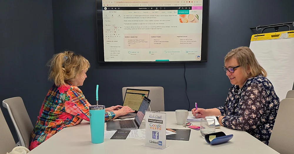 Marketing review meeting with a client at the Effortless Marketing office in Calgary, going over her website on screen